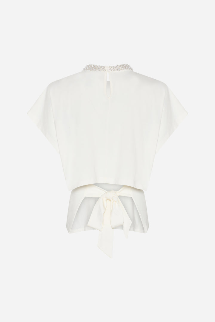 Tämä kaunis T-paita yhdistää trendikkään ilmeen ja kestävän materiaalivalinnan. Valmistettu 95 % luomupuuvillasta ja 5 % elastaanista, paita tuntuu pehmeältä ja mukavalta päällä.