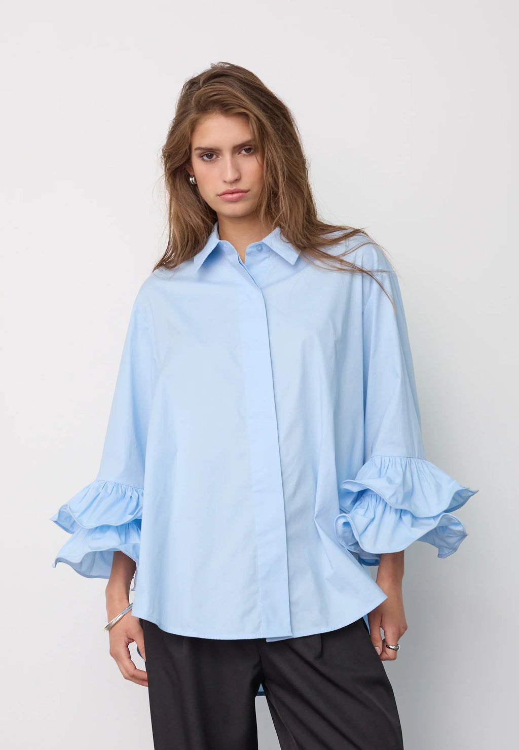 HalenCC Flare Shirt on rento paitapusero frillahihoilla. Kevyesti oversize-malli, 3/4-hihat ja joustava puuvillasekoite. Valkoinen ja vaaleansininen.