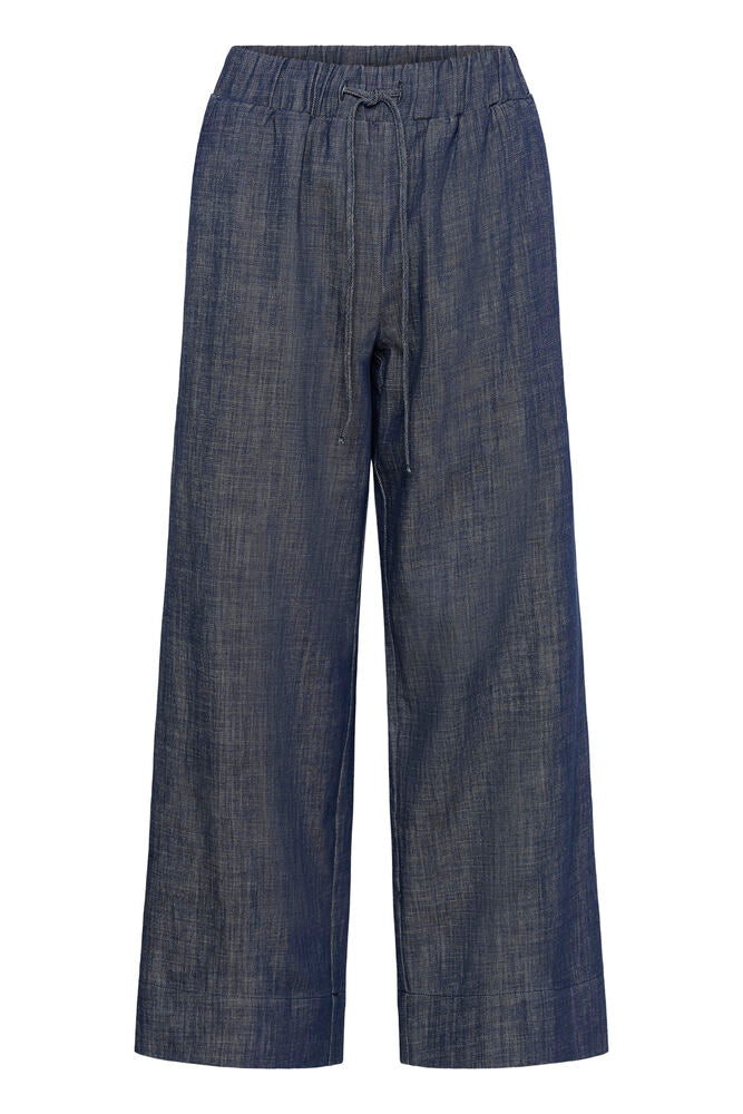 Rennot ja väljät tummansiniset, leveälahkeiset housut. Kuminauhavyötärö. Naisten housukoolla. 