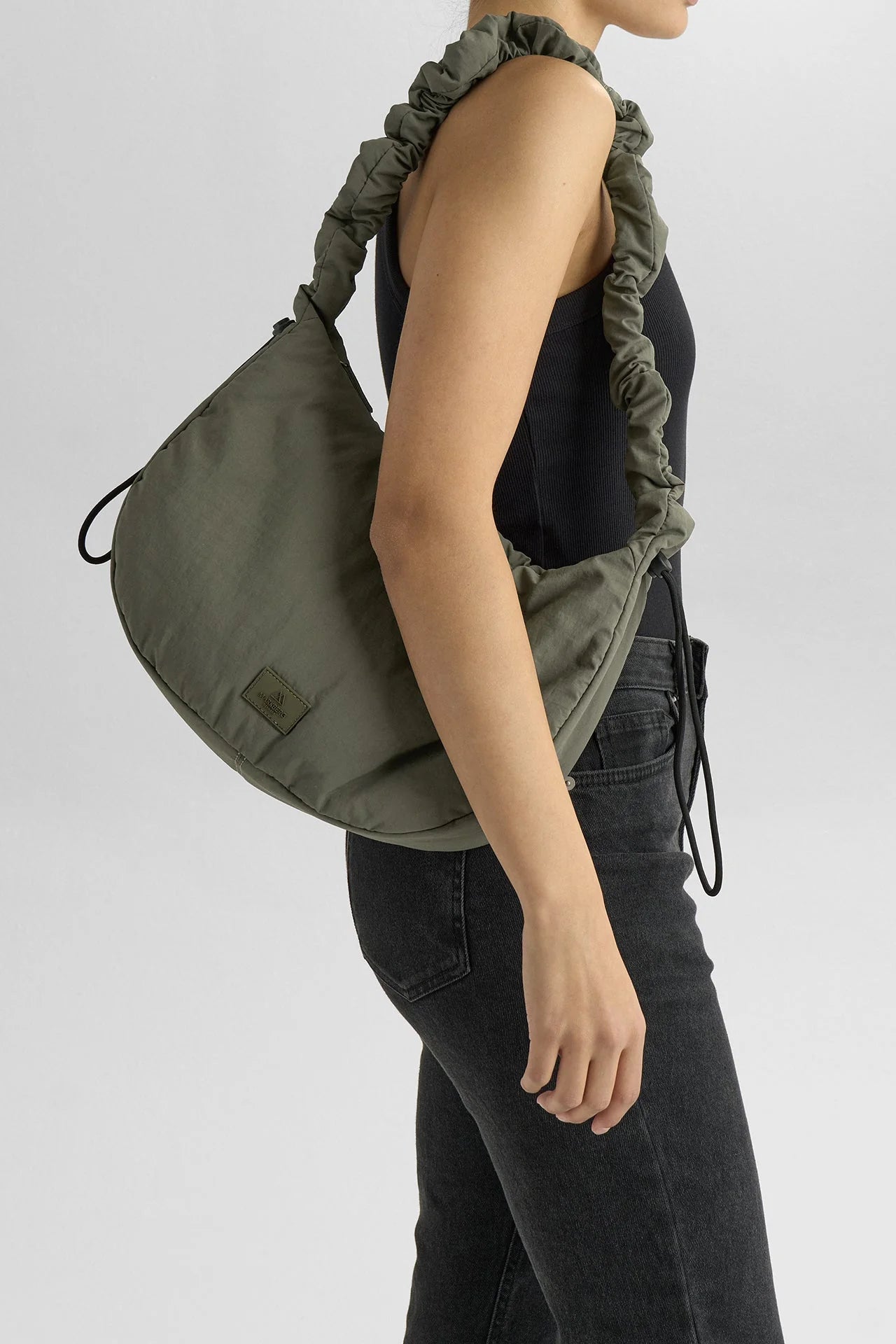 Tämä tyylikäs ja samalla leikkisä crossbody-laukku yhdistää käytännöllisyyden ja kivan ilmeen. Pehmeästi topattu, rypytetty hihna ja säädettävä nyöritys tuovat laukkuun trendikkään twistin.
