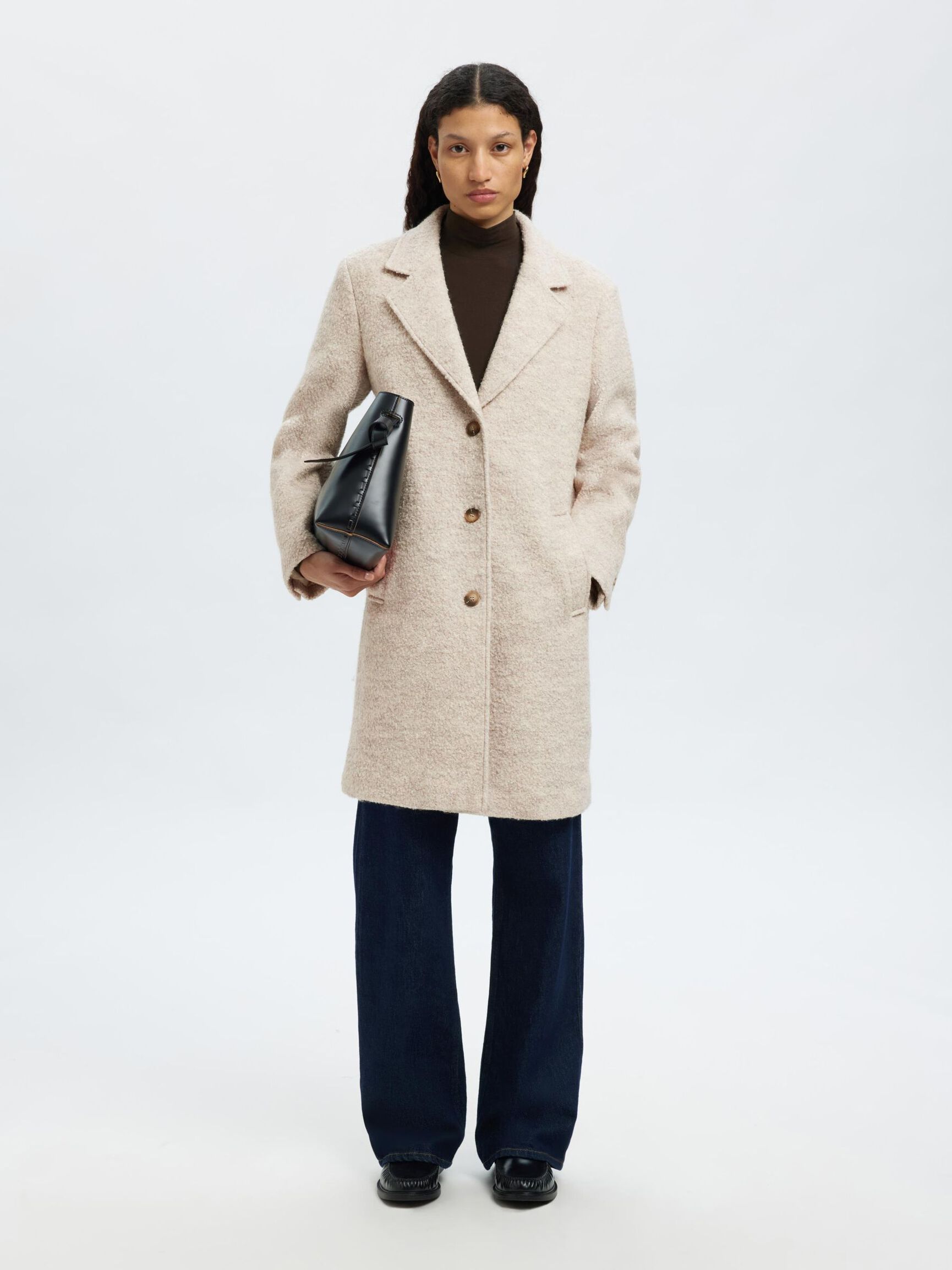 Tämä villasekoitteinen bouclé-takki on ajaton klassikko, joka kuuluu jokaisen naisen vaatekaappiin. Kauniisti teksturoitu bouclé-kangas tuo takkiin elävyyttä ja hienostuneen ilmeen, samalla kun kaunis leikkaus antaa kokonaisuudelle ryhtiä ja eleganssia.